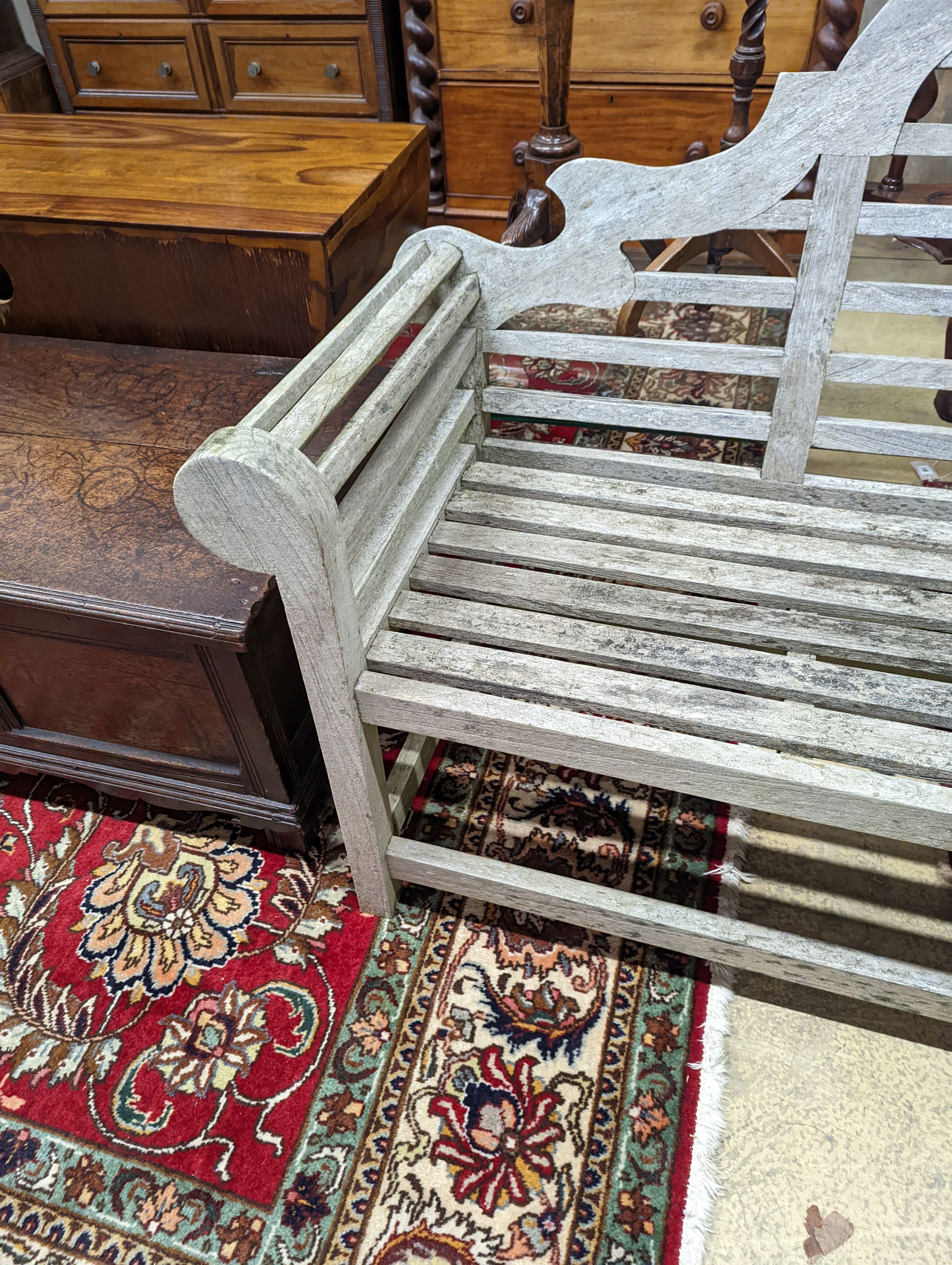 A Lutyens style weathered teak garden bench, length 166cm, depth 52cm, height 104cm